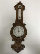 A carved oak barometer