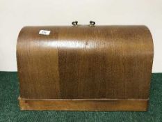 An early 20th century sewing machine in case