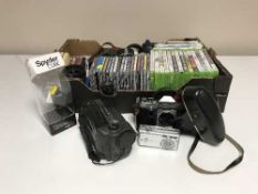 A box of CDs, Xbox games, camera,