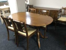An eight piece reproduction mahogany dining room suite