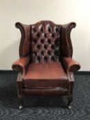 A burgandy leather Chesterfield style chair