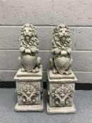 A garden figure - pair of lions on plinths