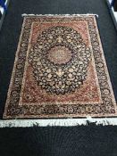 A Keshan fringed rug with silk pile on blue