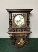 A late Victorian walnut wall clock with enamelled dial