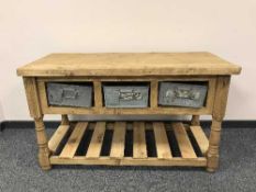 A reclaimed pine side table fitted with three galvanised drawers with rack below
