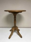 An oak pedestal occasional table