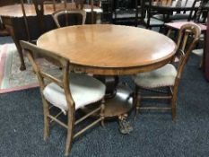 A Victorian mahogany pedestal breakfast table on lion paw feet with three Victorian chairs