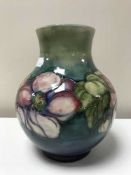 William Moorcroft vase, Clematis pattern with blue\green background, circa 1950's, height 19cms.