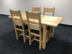 A light oak dining table and four chairs
