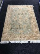 A Zeigler fringed rug with silk pile on green