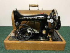 An early 20th century sewing machine in case