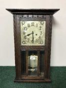 An Edwardian oak wall clock