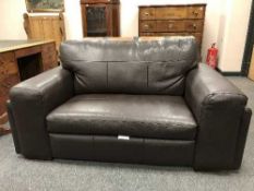 A brown leather contemporary three seater settee together with matching two seater settee.