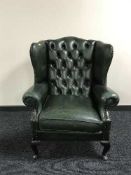 A green Chesterfield wing armchair