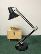 An angle poised lamp and a shoe shining kit