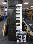 A Technics KN 1000 electric keyboard with stand and accessories