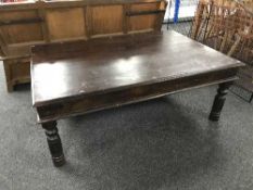 A rectangular hardwood coffee table with metal mounts