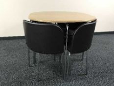 A contemporary kitchen table and four leather chairs