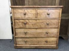 An antique pine five drawer chest