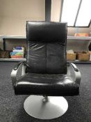 A black leather metal framed swivel armchair