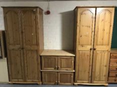 A pair of pine double door wardrobe with top boxes
