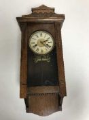 An Edwardian oak wall clock