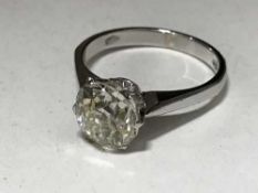 An 18ct gold diamond solitaire ring, the cushion cut stone weighing approximately 2.