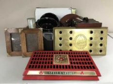 A box of metal advertising signs, school style clock,
