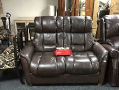 A brown leather two seater settee