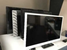 A Toshiba 24 inch LCD TV with remote and three other LCD TVs