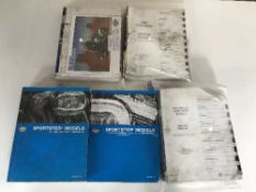 A crate of five assorted Harley Davison & Bewell service manuals
