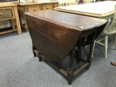 An antique oak gate leg table