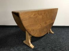 An Ercol elm drop leaf table