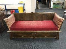 A carved oak framed drop end settee