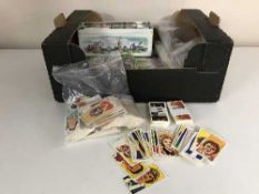 A box of assorted tea cards, tea card books,