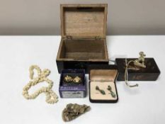 A jewellery box containing a pair of earrings, carved necklace, carving,