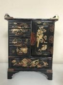 An oriental lacquered miniature chest