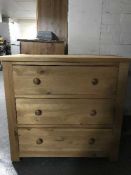 A pine three drawer chest
