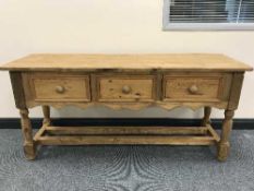 A reclaimed pine table fitted three drawers