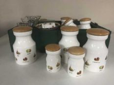 Two boxes of 13 fruit pattern storage jars and kitchen ware
