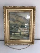 A gilt framed watercolour depicting a farm in rural landscape