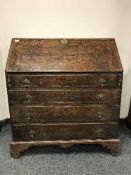 An 18th century oak bureau on bracket feet