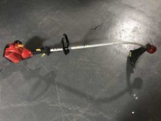 A Homelite Mighty Lite petrol strimmer