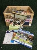 Two boxes of assorted football programmes