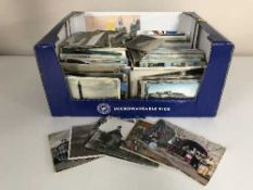 Four boxes containing a large quantity of assorted 20th century postcards