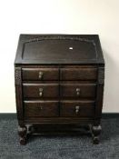 A carved oak bureau