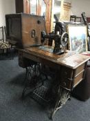 Singer treadle sewing machine in table and mid 20th century TV in case
