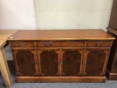 A reproduction yew wood sideboard