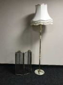 A four way brass folding spark guard and a brass & marble standard lamp