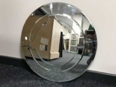 A circular contemporary un-framed mirror